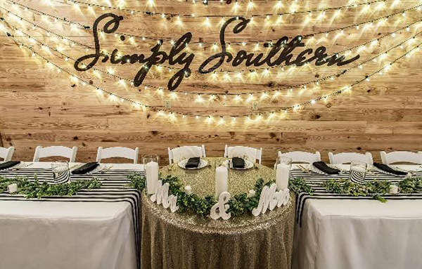 Sign and dining tables at Simply Southern Barn